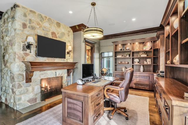 office area with recessed lighting, a fireplace, light wood-type flooring, and crown molding