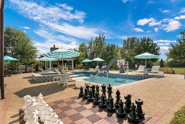 view of pool with a fenced in pool, a patio, a water slide, and fence