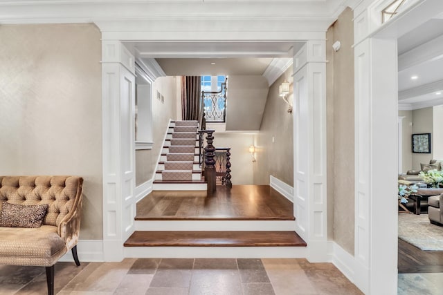 stairs featuring visible vents, ornamental molding, stone finish floor, baseboards, and ornate columns