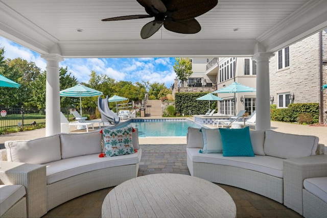 exterior space featuring outdoor dining space, an outdoor living space, a water slide, a fenced in pool, and a patio area