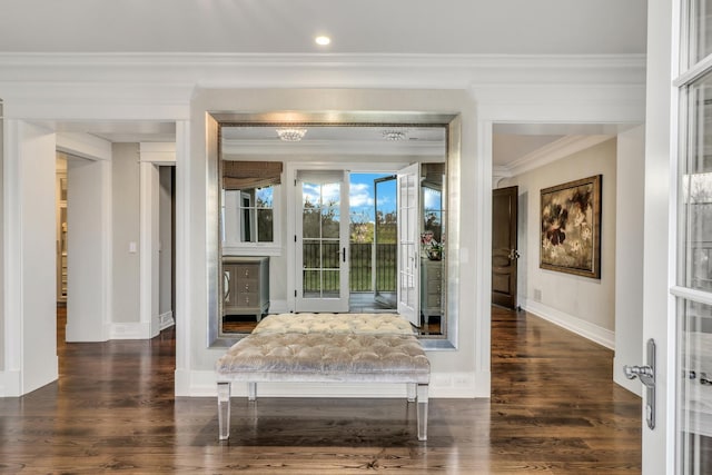 interior space with ornamental molding, baseboards, and wood finished floors