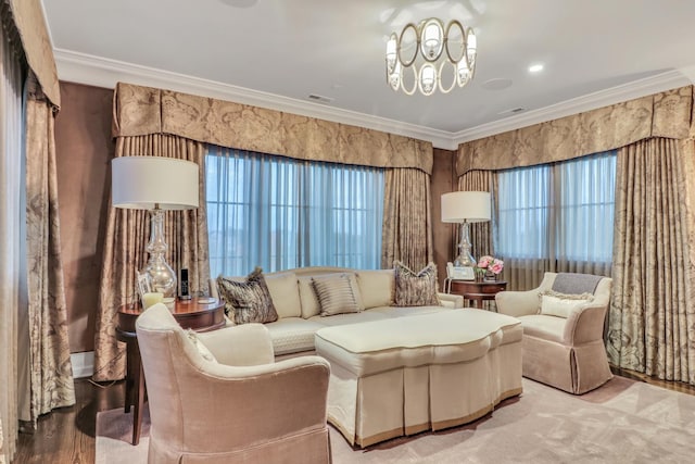 sitting room with an inviting chandelier, a healthy amount of sunlight, and ornamental molding