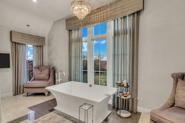 sitting room with visible vents, baseboards, and a chandelier