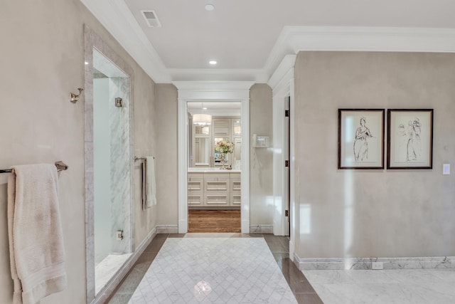 bathroom featuring vanity, baseboards, visible vents, ornamental molding, and a shower stall