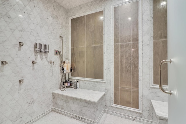 bathroom with a shower and tile walls