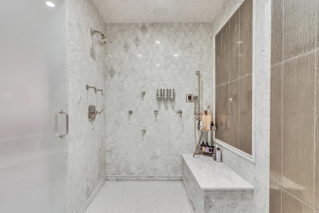 full bath featuring a shower stall and a textured ceiling