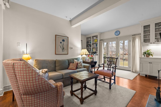 living room with beamed ceiling, french doors, and wood finished floors