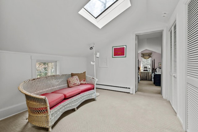 living area with lofted ceiling with skylight, baseboards, a baseboard heating unit, and carpet