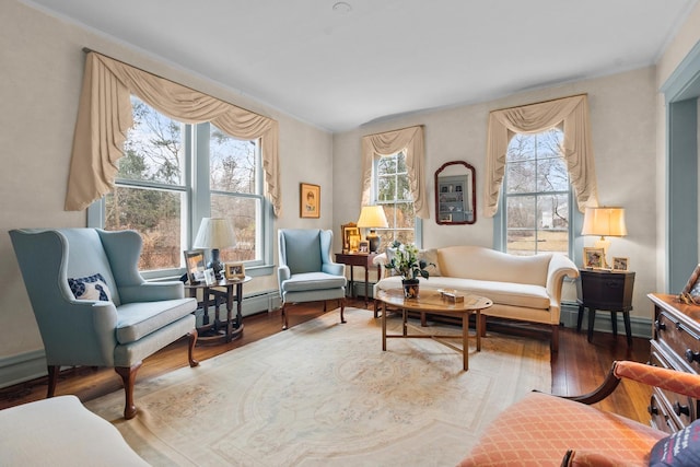 living area with wood finished floors and baseboards