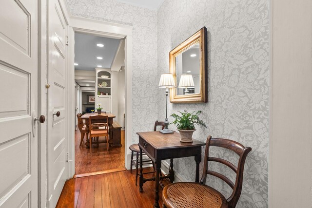 hallway featuring recessed lighting, wallpapered walls, and hardwood / wood-style floors