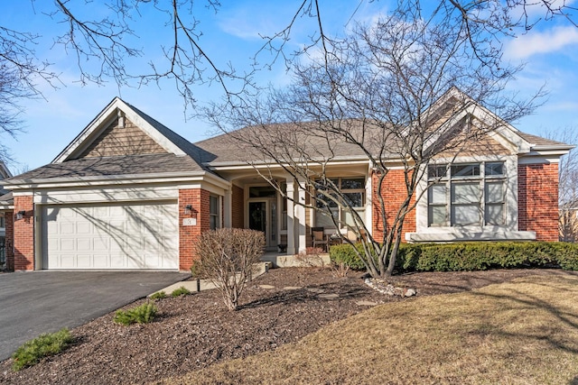 ranch-style house featuring a front lawn, brick siding, an attached garage, and driveway