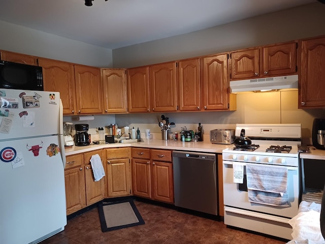 kitchen with white appliances, light countertops, and under cabinet range hood