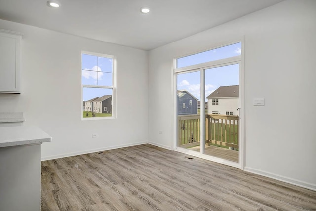 unfurnished room featuring visible vents, recessed lighting, light wood-style floors, and baseboards