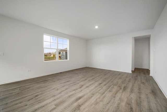 empty room featuring recessed lighting and wood finished floors