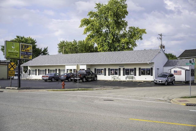 view of building exterior featuring uncovered parking