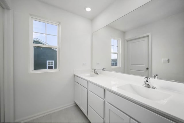 full bathroom with a sink, baseboards, recessed lighting, and double vanity