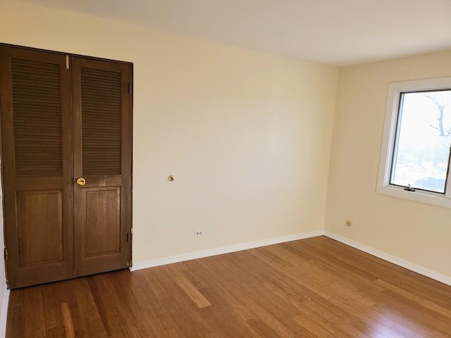 unfurnished bedroom with baseboards and wood finished floors