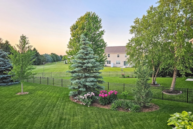 yard at dusk with a rural view and fence