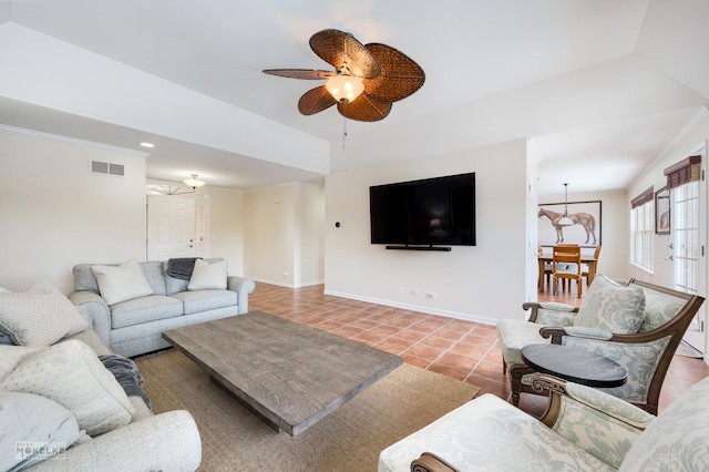 living room with tile patterned floors, visible vents, crown molding, baseboards, and ceiling fan