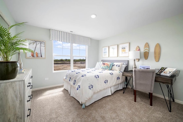 bedroom featuring light colored carpet and baseboards