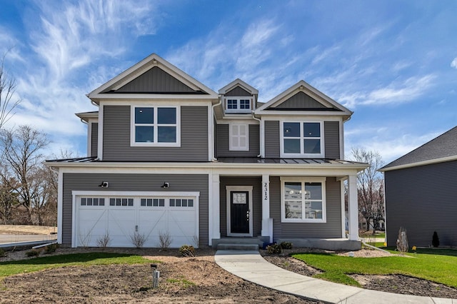 view of front of home featuring a standing seam roof, board and batten siding, covered porch, an attached garage, and metal roof