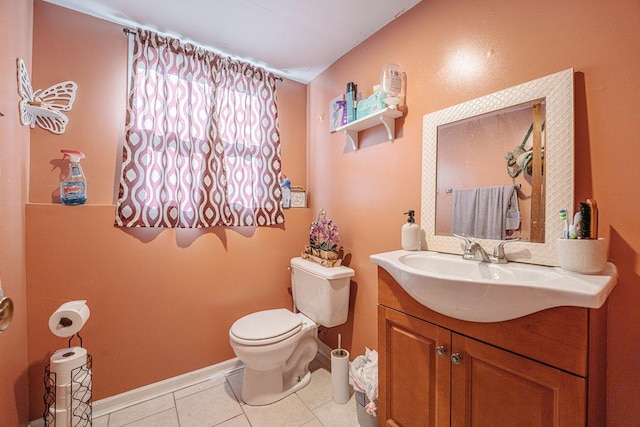 bathroom with vanity, tile patterned floors, toilet, and baseboards