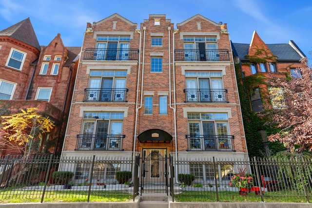 view of front of house featuring a fenced front yard and brick siding