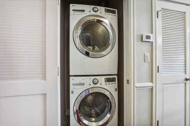 washroom featuring laundry area and stacked washing maching and dryer