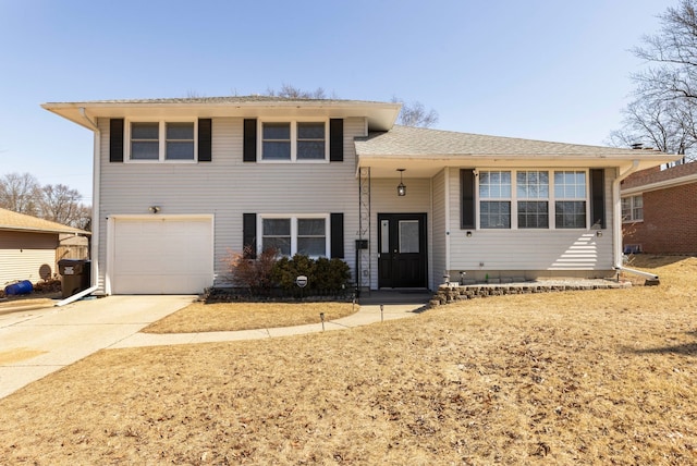 tri-level home with concrete driveway and an attached garage