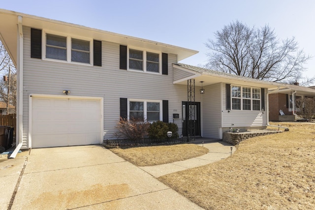 split level home featuring concrete driveway and a garage