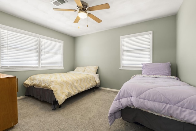 bedroom with visible vents, multiple windows, baseboards, and carpet floors