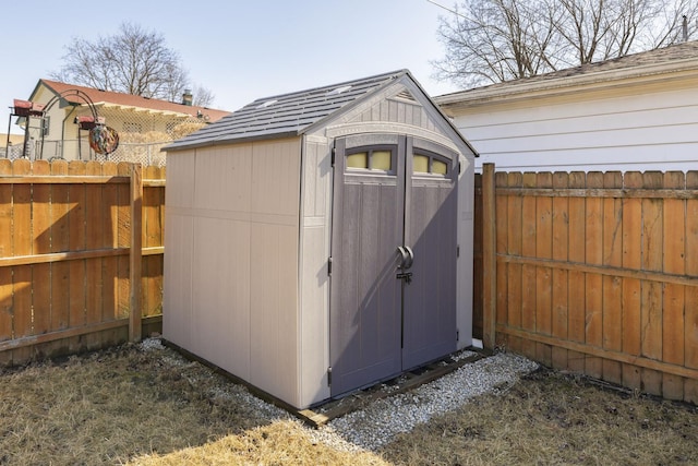 view of shed with a fenced backyard