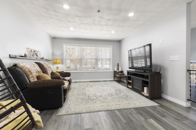 living area featuring recessed lighting, baseboards, and wood finished floors