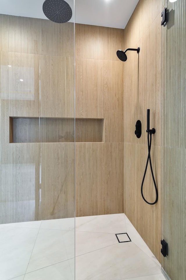 full bath with a tile shower