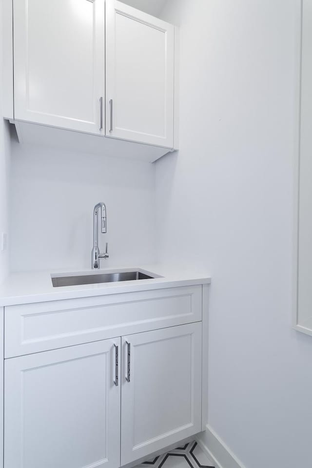 bar featuring a sink and baseboards