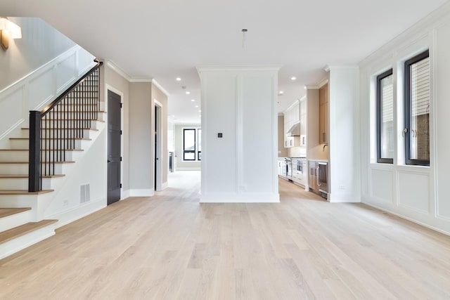 unfurnished living room with visible vents, recessed lighting, light wood-style floors, and stairs