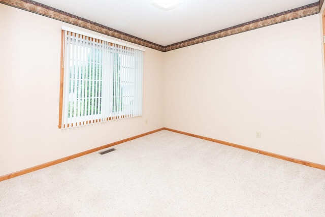 carpeted empty room with baseboards and visible vents