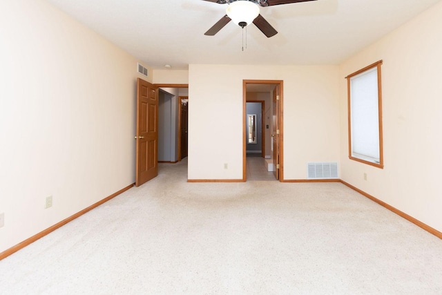 spare room with visible vents, light carpet, and baseboards