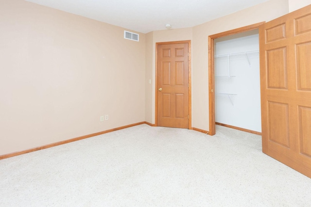 unfurnished bedroom with baseboards, visible vents, a closet, and light carpet