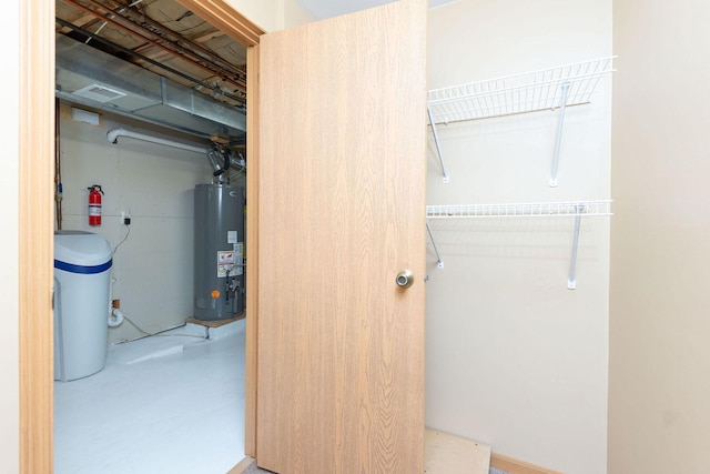 closet with visible vents and gas water heater