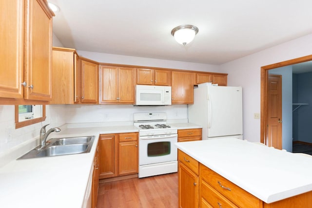 kitchen featuring light wood-type flooring, a sink, backsplash, white appliances, and light countertops