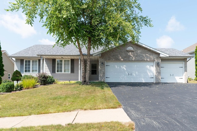 ranch-style home featuring a front lawn, an attached garage, driveway, and a shingled roof