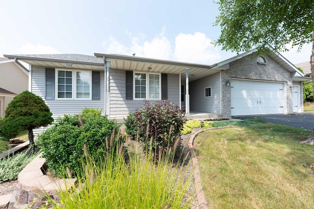 ranch-style home with a front yard, an attached garage, a porch, and driveway