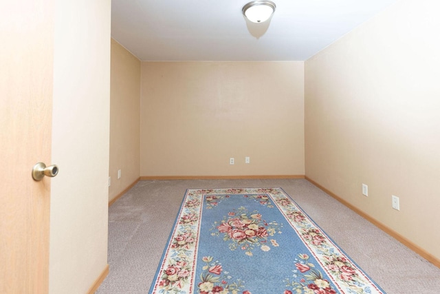 spare room with carpet flooring and baseboards