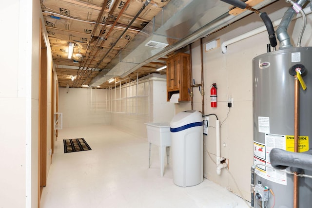 unfinished basement with visible vents and water heater