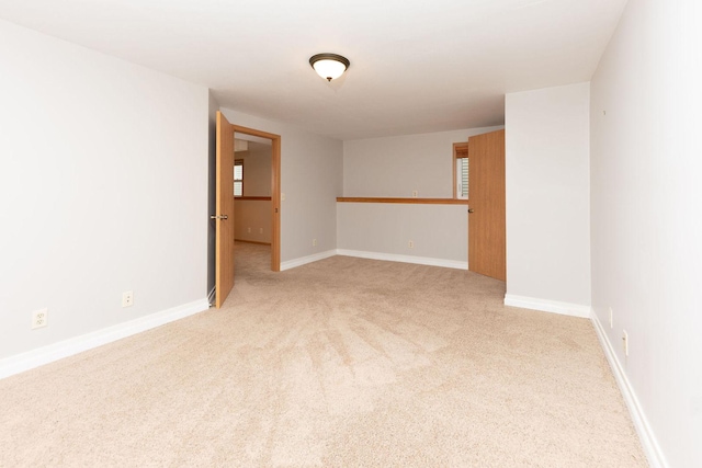 empty room with light carpet and baseboards