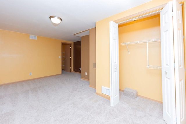 unfurnished bedroom featuring a closet, visible vents, carpet flooring, and baseboards