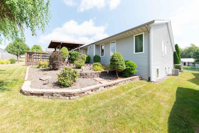 exterior space featuring a front lawn and cooling unit