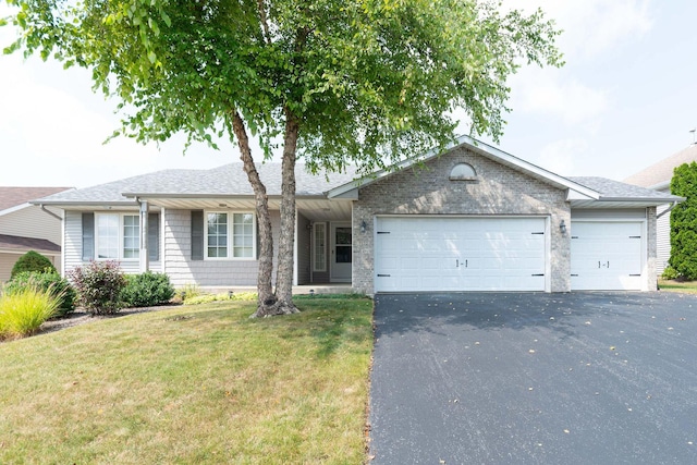 single story home with aphalt driveway, an attached garage, a front lawn, and roof with shingles