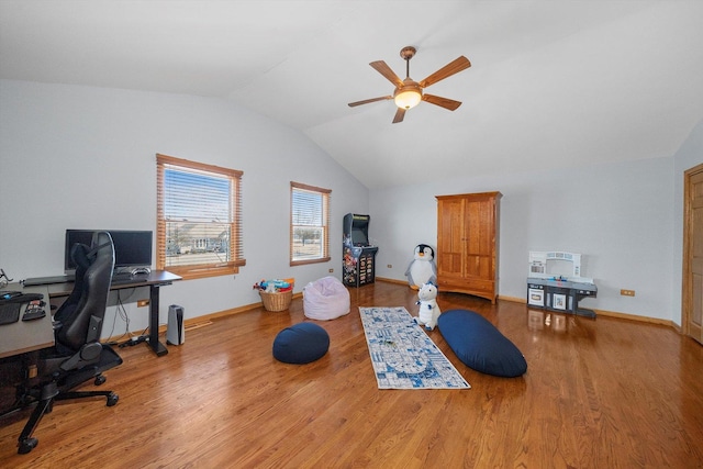 home office featuring lofted ceiling, wood finished floors, baseboards, and ceiling fan